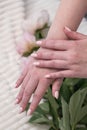 female hands with a beautiful peach manicure design, color 2024, pastel colors, delicate spring dewy peonies