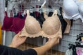 Female hands with beige bra in underwear shop Royalty Free Stock Photo