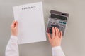 Female hands, business contract and calculator. Royalty Free Stock Photo