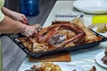 female hands butchering a goose baked in the oven