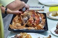 female hands butchering a goose baked in the oven