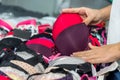 Female hands choosing bra in underwear shop, closeup Royalty Free Stock Photo