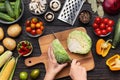 Female hands chopping savoy cabbage on wooden board Royalty Free Stock Photo