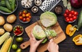 Female hands chopping savoy cabbage on wooden board Royalty Free Stock Photo