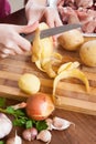 Female hands cleaning potatoes