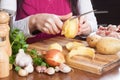 Female hands cleaning potatoes