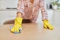 young woman cleaning wooden table with microfiber cloth. Royalty Free Stock Photo