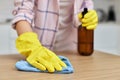 young woman cleaning wooden table with microfiber cloth. Royalty Free Stock Photo