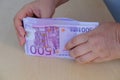 female hands close-up counting paper 500 euro banknotes, concept cash, payments, savings, banking, return money debt, car, win in Royalty Free Stock Photo