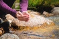 female hands close-up draw water from a mountain stream to quench thirst, drink from a clean source of water. tourist on Royalty Free Stock Photo