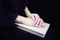 Female hands on a closed book