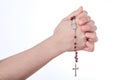 Female hands closed in prayer holding a rosary Royalty Free Stock Photo