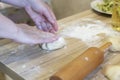 Female hands closeup make the dough