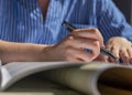 Female hands closeup with pen taking notes, writing in notebook Royalty Free Stock Photo