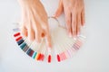 Female hands and colorful nail varnish palette Royalty Free Stock Photo