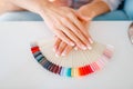 Female hands and colorful nail varnish palette Royalty Free Stock Photo