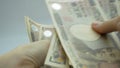 Female hands counting japan money banknotes