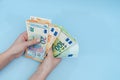 Female hands counting stack of euro banknotes on blue background. Money. Business. Finance Royalty Free Stock Photo