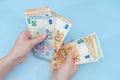 Female hands counting stack of euro banknotes on blue background. Money. Business. Finance Royalty Free Stock Photo