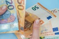 Female hands counting stack of euro banknotes on blue background. Money. Business. Finance Royalty Free Stock Photo