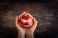 Female hands cradling beautiful Christmas bauble.