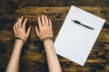 Female hands cuffed, top view of police investigator desk Royalty Free Stock Photo