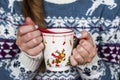 Female hands with a cup of hot tea