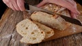 Female hands cut appetizing bread Royalty Free Stock Photo