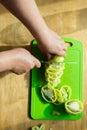 female hands cut green pepper with a knife. Royalty Free Stock Photo