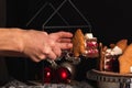 Female hands cut a piece of cake Black Forest decorated in Christmas style. Royalty Free Stock Photo