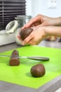 Female hands cut the prepared dough into pieces and form balls from it. Royalty Free Stock Photo