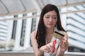 Female hands cutting credit card with scissors.