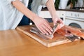 Female hands cutting fillet of red fish. Red caviar. Removing fish bones. Butchering red fish meat...Food concept.