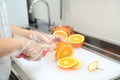 Female hands cutting fresh juicy orange Royalty Free Stock Photo