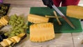 Female hands cutting with knife ripe pineapple to slice. Female shef cutting fresh pineapple for serving fruit snacks.