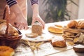 Female hands cutting whole wheat bread