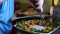 Female Hands Decorate Roasted Whole Chicken on Plate For Family Dinner Royalty Free Stock Photo