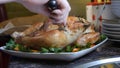 Female Hands Decorate Roasted Whole Chicken on Plate For Family Dinner Royalty Free Stock Photo