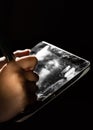 Female hands digitally sign a digital tablet on black dark background with copy space. Royalty Free Stock Photo