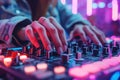 female hands of DJ girl mixes music on DJ console mixer at a nightclub in night party