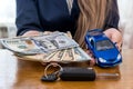 Female hands with dollars, car and keys Royalty Free Stock Photo