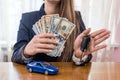 Female hands with dollars, car and keys Royalty Free Stock Photo