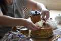 Female hands fill a pancake with cottage cheese