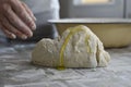 Female hands in flour kneading dough