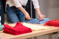 Female fold blue clothes at clothing store