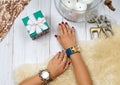 Female hands with gift. Fashion accessories, wrist watches, glamor bracelets