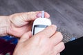 Female hands and glucometer measuring blood sugar