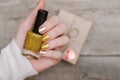 Female hands with gold nail design