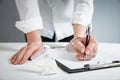 Female hands in handcuffs fill out police report recognition Royalty Free Stock Photo