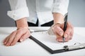 Female hands in handcuffs fill out police report recognition Royalty Free Stock Photo